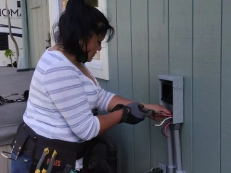 Licensed electrician wiring an exterior subpanel in Gladstone